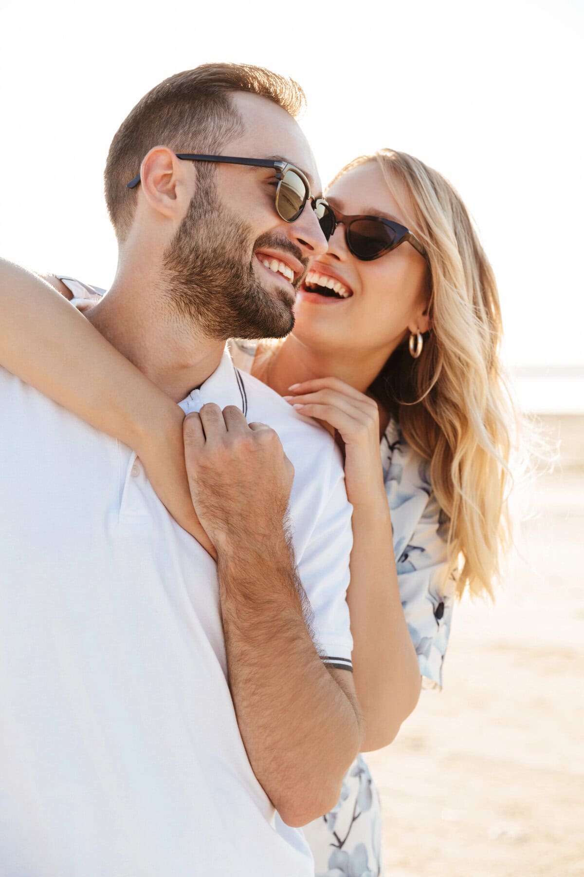 Healing, happy couple at the beach enjoying sunny weather.