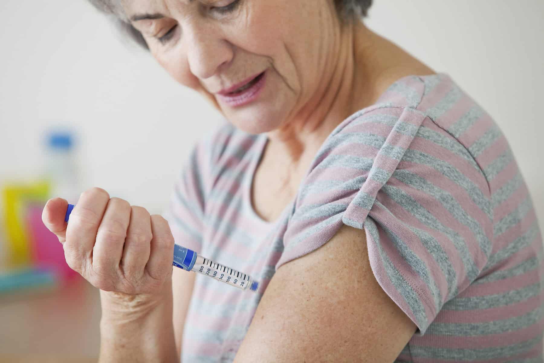 Syringe-injection-vaccine-treatment-elderly-woman-in-clinic.