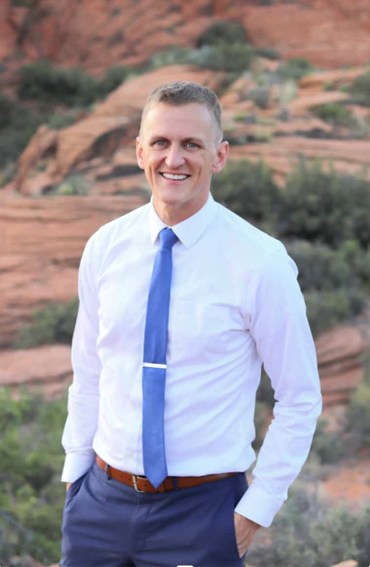 John Doe standing outdoors with a rocky desert backdrop in St. George, Utah.