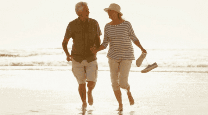 Enjoying a walk on the beach in St. George, Utah Elderly couple walking on the beach during sunset in Utah.